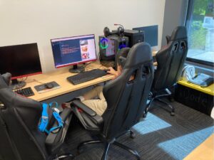 Student coding in comfortable gaming hub