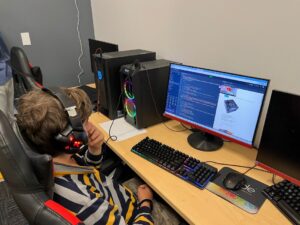 Student coding in html, css, and javascript.