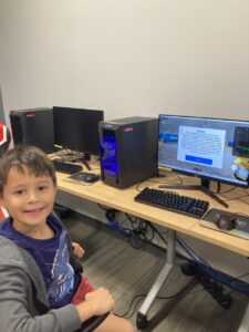 Happy kid with a computer