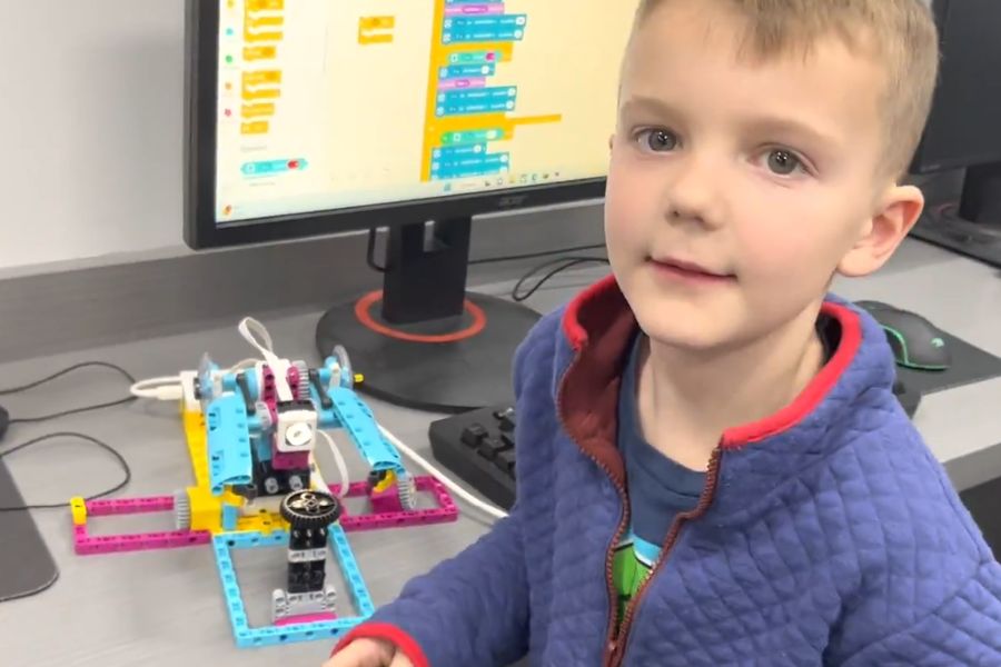 A young student coding a LEGO SPIKE Prime robot