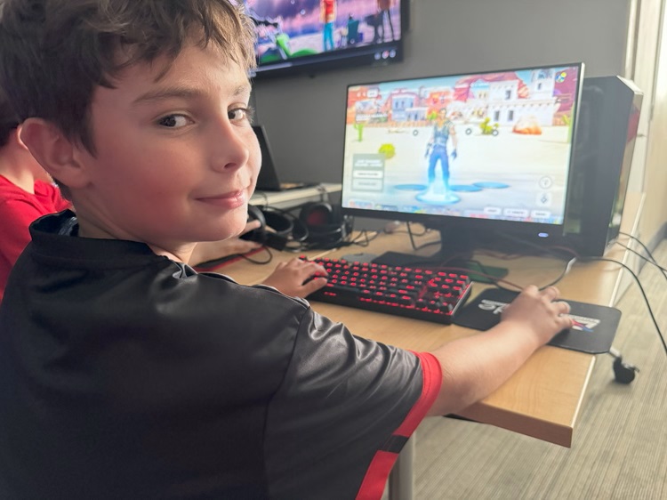 A competitor plays Fortnite for iCode Frisco's esports team